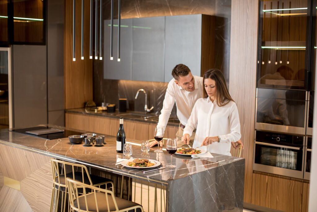 Sweet-Couple-Having-A-Romantic-dinner-wolfe-appliance-in-kitchen