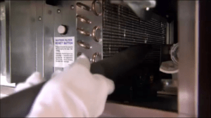 hand-Cleaning-condenser-coil-with-soft-brush