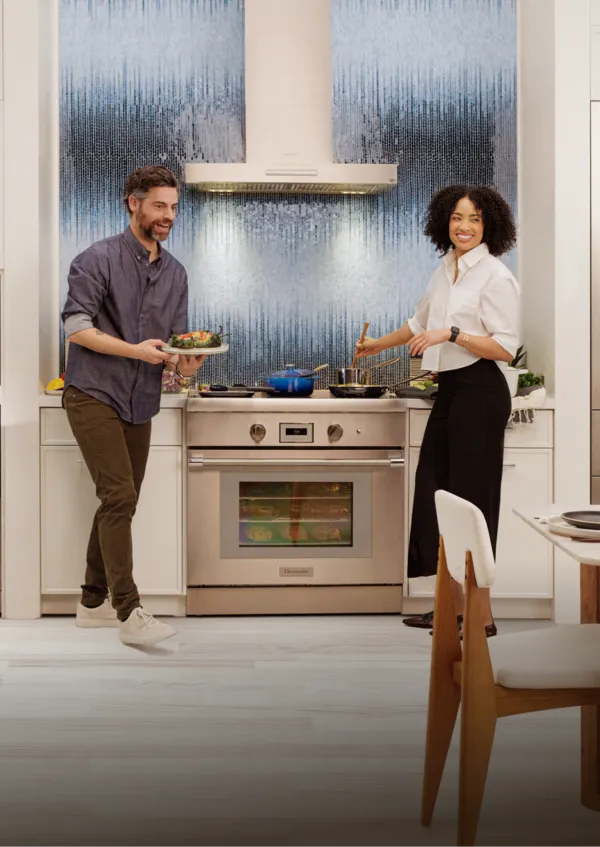 Two people in luxury kitchen.