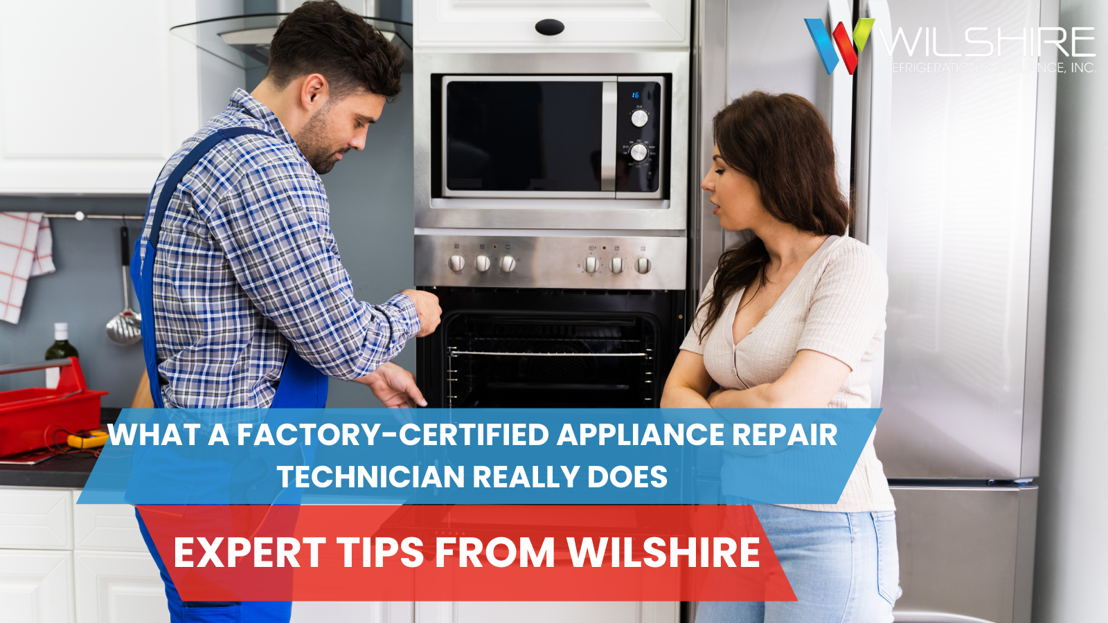 A repair person in blue overalls looks at an oven with an open door, while another person stands by with arms crossed.