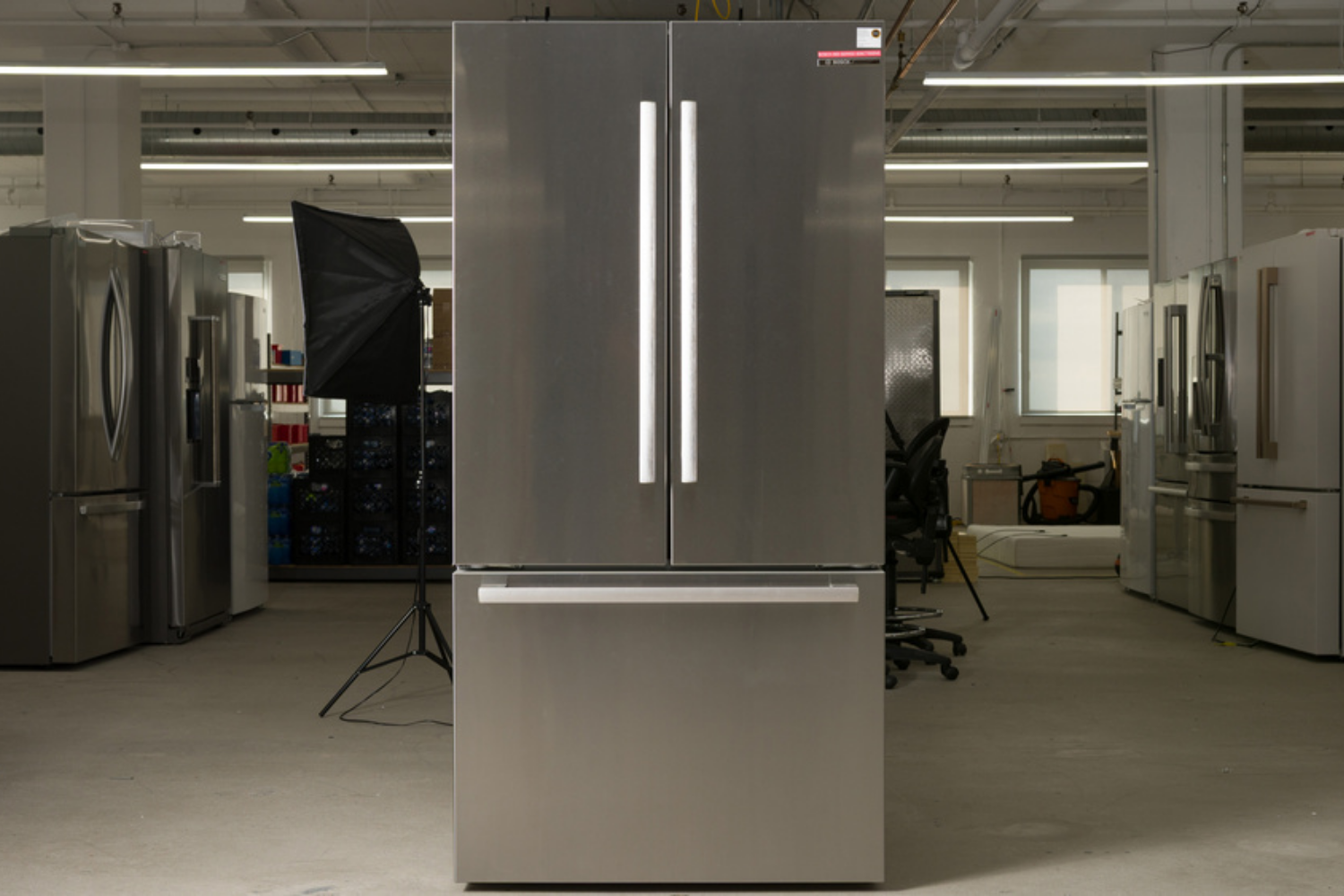 A stainless steel refrigerator with a double-door upper section and a single drawer below.