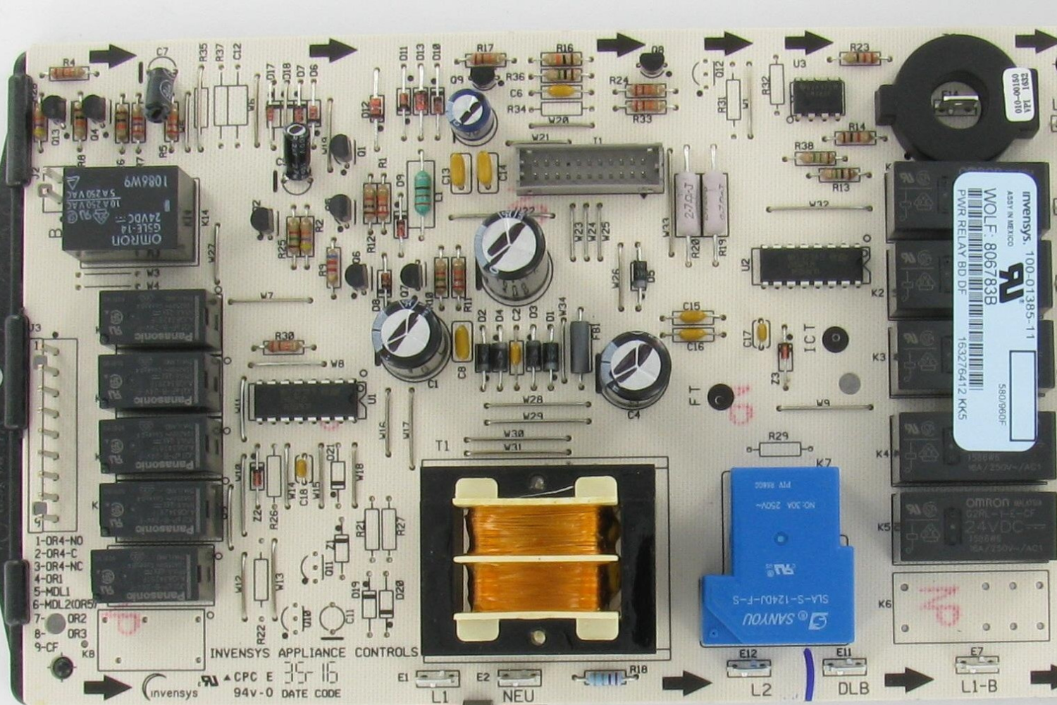 Close-up of appliance control board with labeled components, relays, and copper transformer.