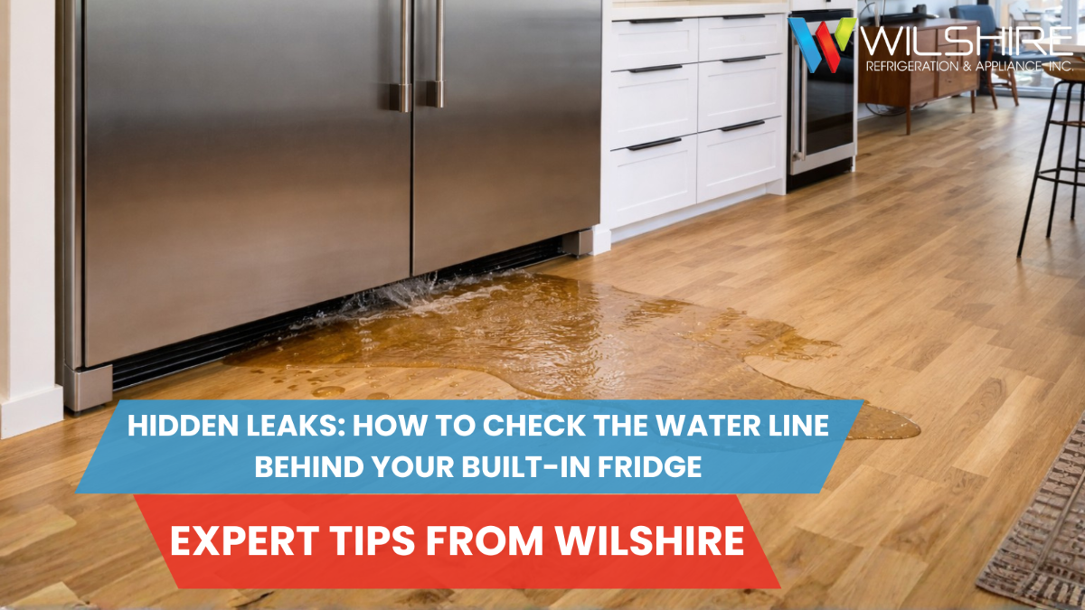 Built-in stainless steel refrigerator leaking water onto hardwood kitchen floor due to hidden water line issue; overlaid text reads “Hidden Leaks: How to Check the Water Line Behind Your Built-In Fridge – Expert Tips from Wilshire.”