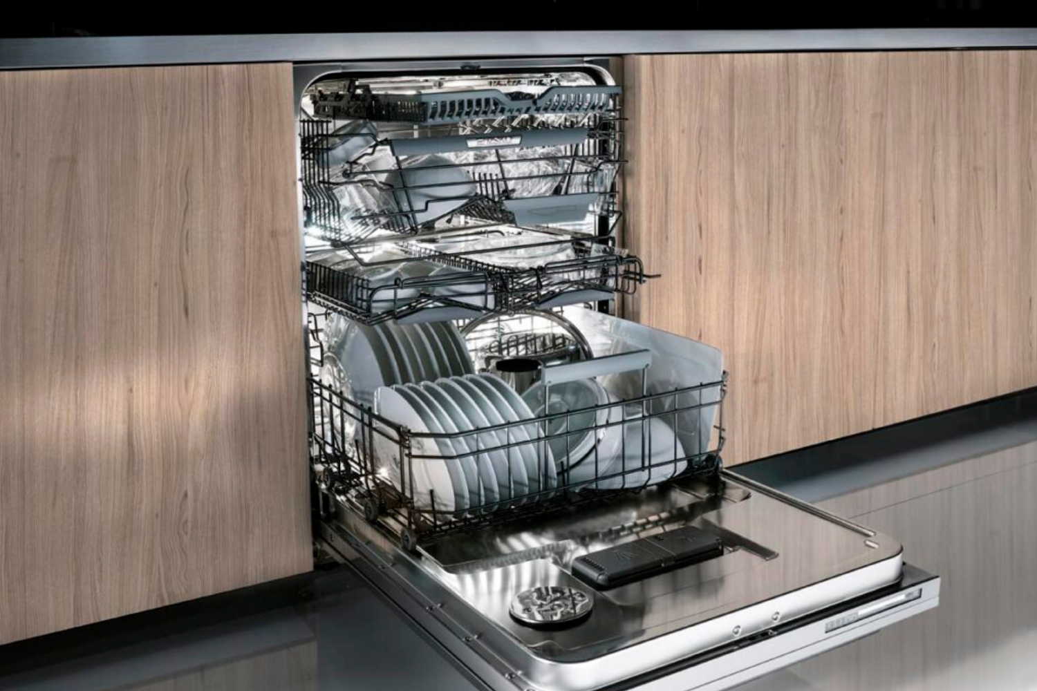 Fully loaded built-in dishwasher with organized racks and stainless steel interior.