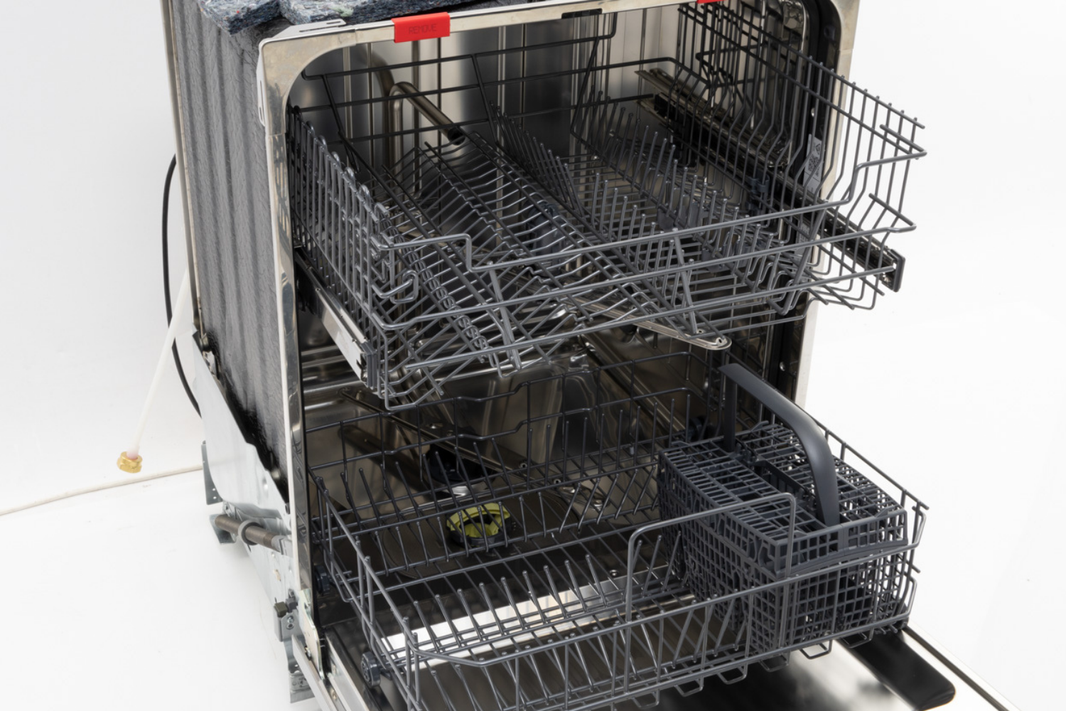 Empty dishwasher with organized racks and utensil basket.