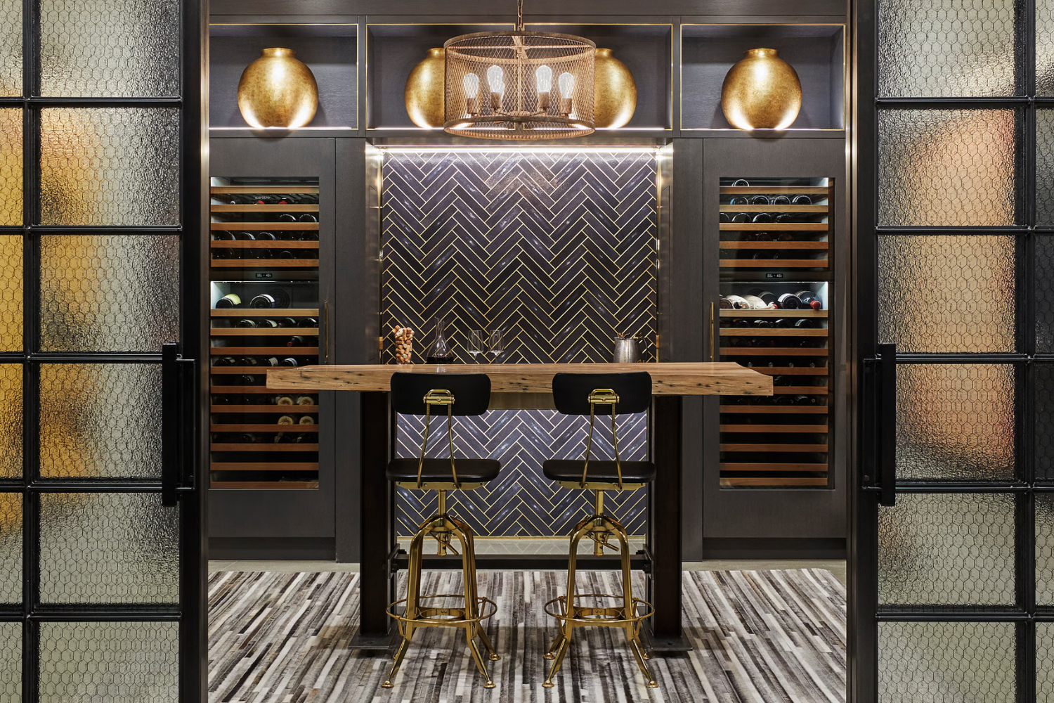 Built-in Sub-Zero wine refrigerators create a controlled storage environment for valuable collections in luxury home wine rooms.