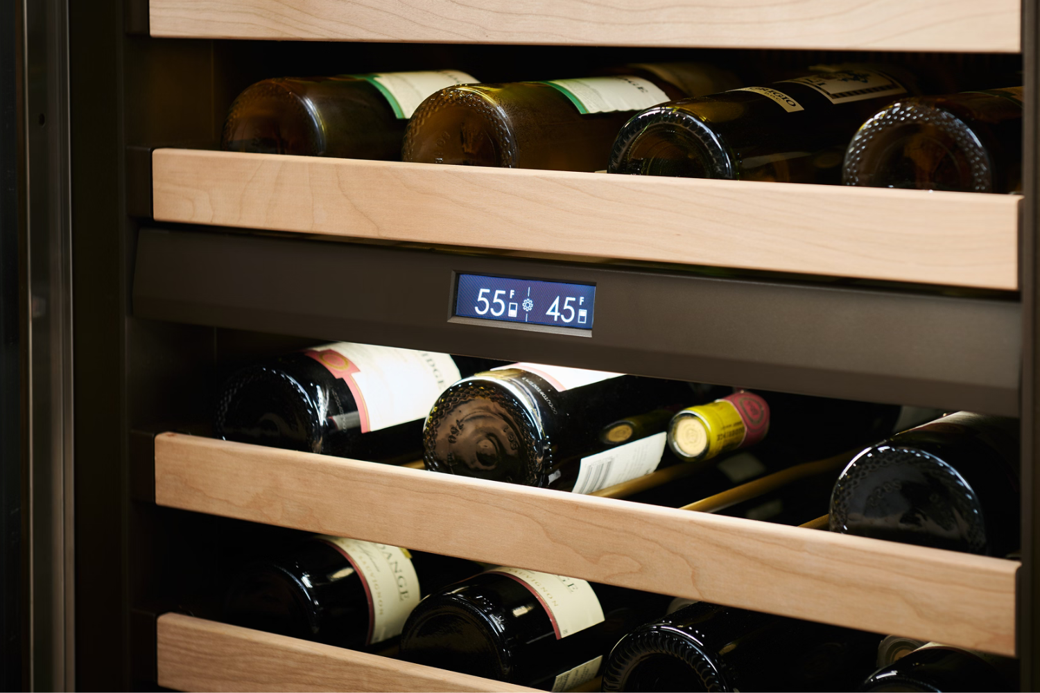Sub-Zero wine fridge with bottles stored on wooden racks and digital temperature display