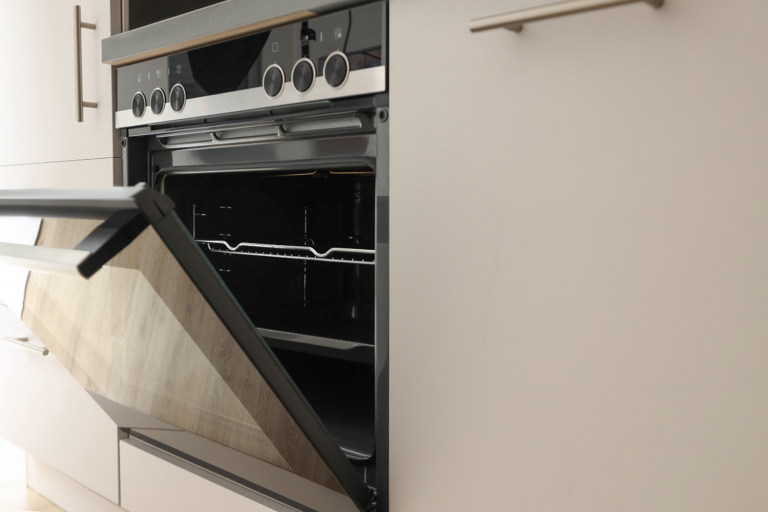 Built-in oven with door partially open showing an oven door that may not close all the way.