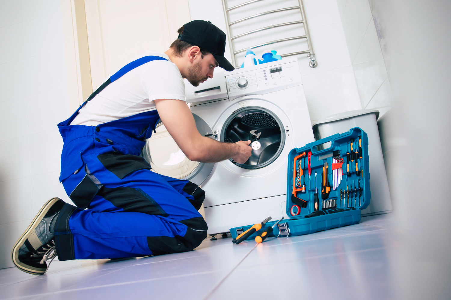 Technician inspecting a front-load washer
