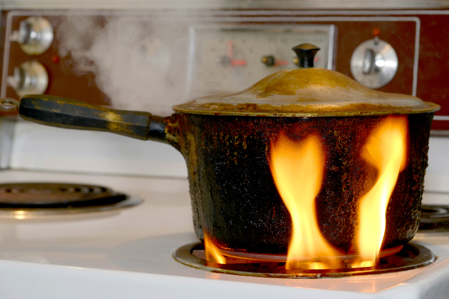 Stovetop pot with large yellow burner flames during a gas stove combustion problem