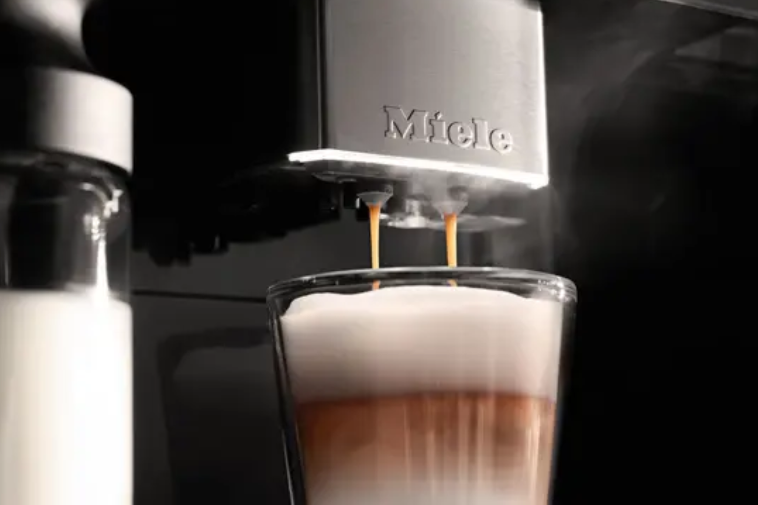 Close-up of Miele coffee machine dispensing espresso during luxury appliance service inspection.