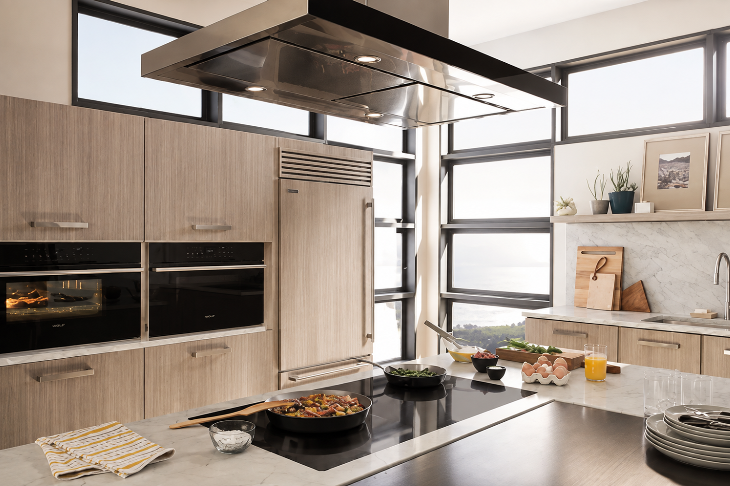 Modern kitchen with built-in Sub-Zero refrigerator, ovens, cooktop, cabinetry, and ventilation arranged for good ventilation.