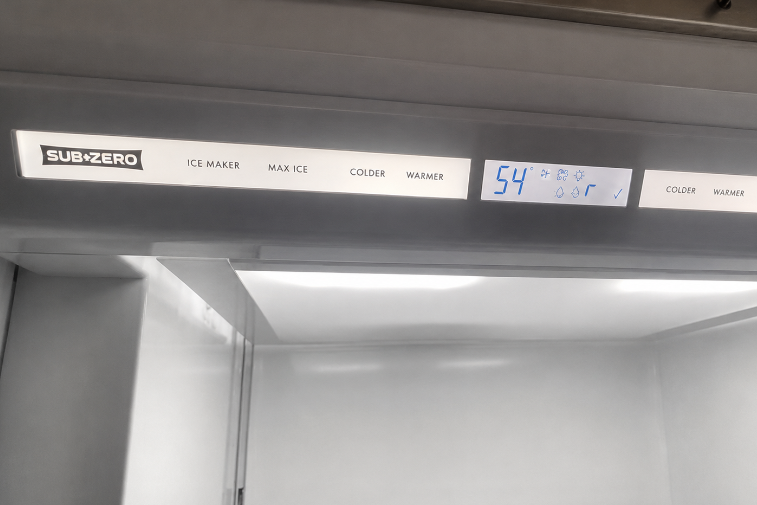 Sub-Zero refrigerator interior control panel showing a digital 38°F temperature setting.