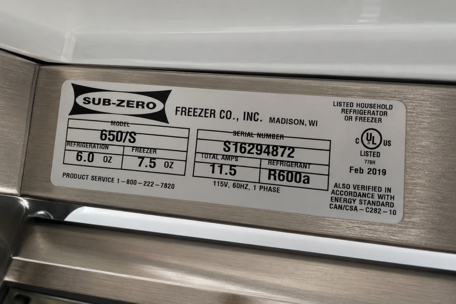 Close-up of a Sub-Zero freezer nameplate showing model 650VS, serial number S16294872, electrical specs 115V 60Hz 1 phase, refrigerant R600A, and listed household use information.