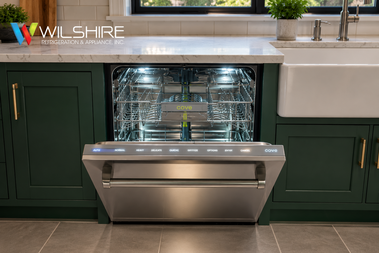 Open Cove dishwasher built into green cabinetry with stainless steel interior and illuminated control panel, showcasing a high‑end modern kitchen appliance.