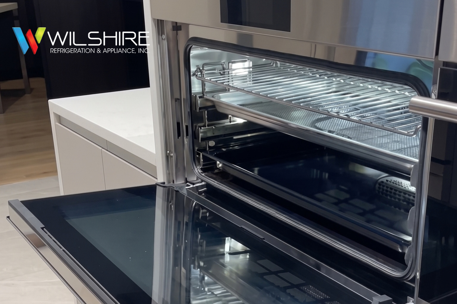 Wolf built‑in stainless steel steam oven with open glass door, integrated into modern kitchen island cabinetry and polished countertop.
