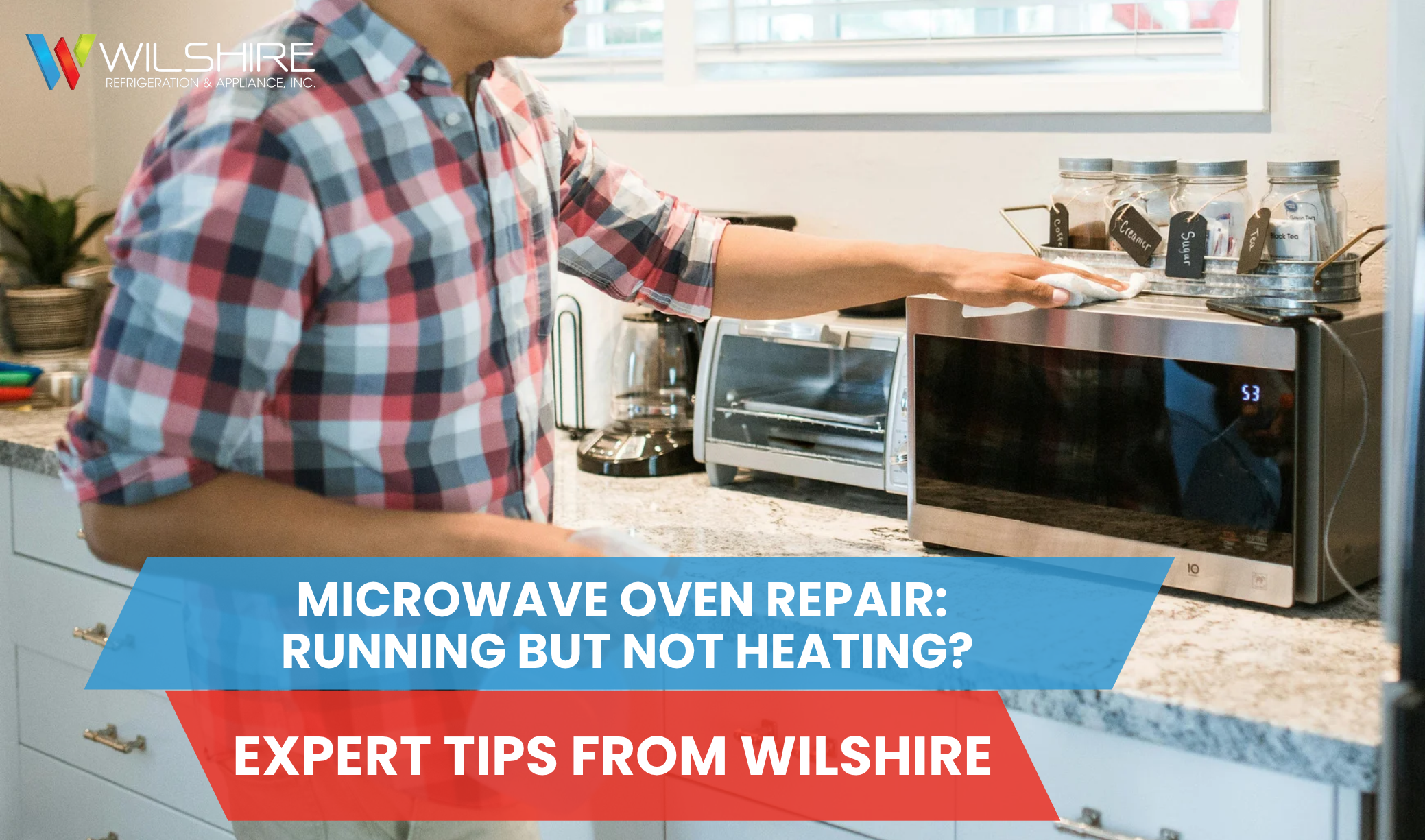 A person wiping down a microwave in a kitchen