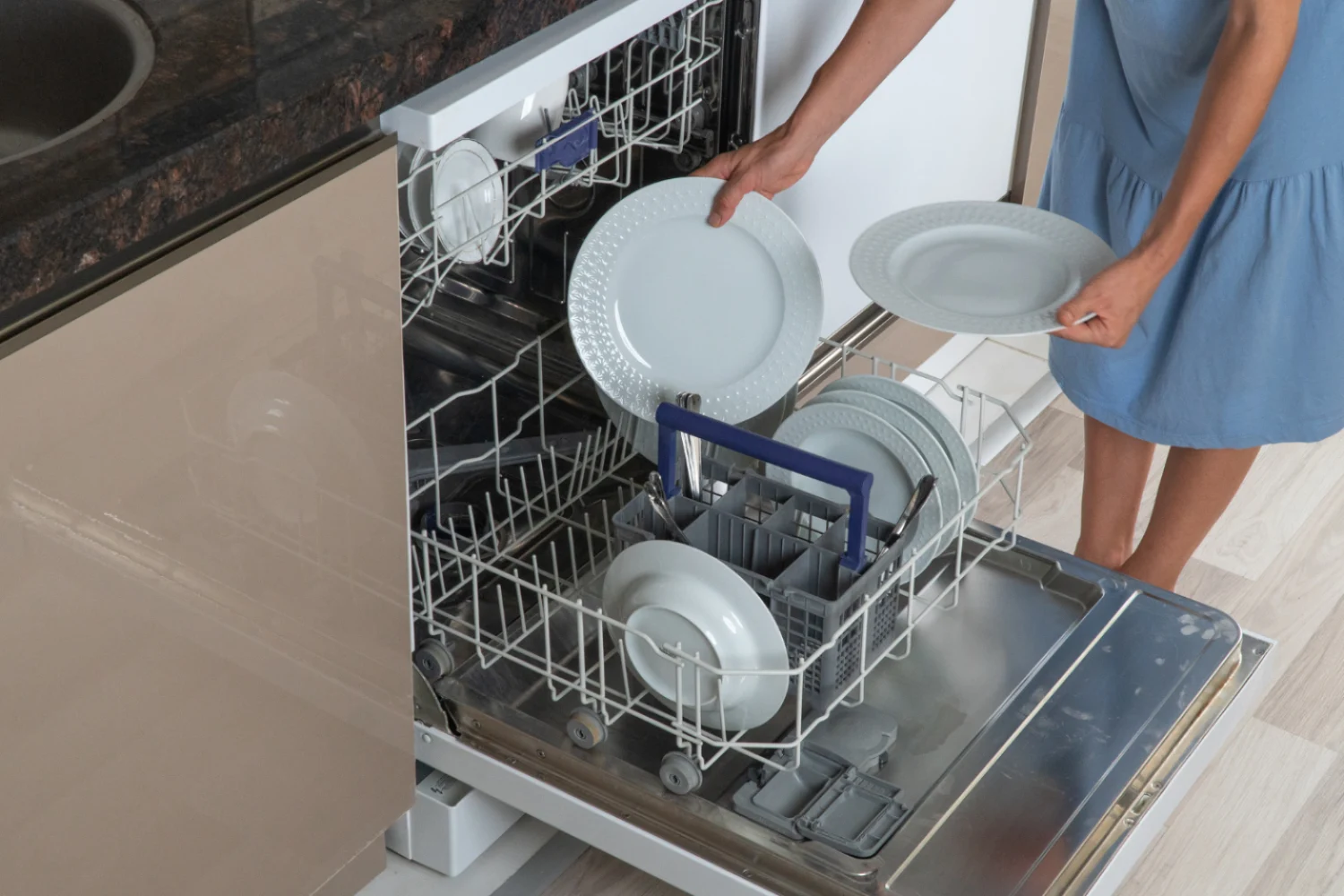 Open dishwasher being loaded with dishes before Viking appliance repair diagnosis